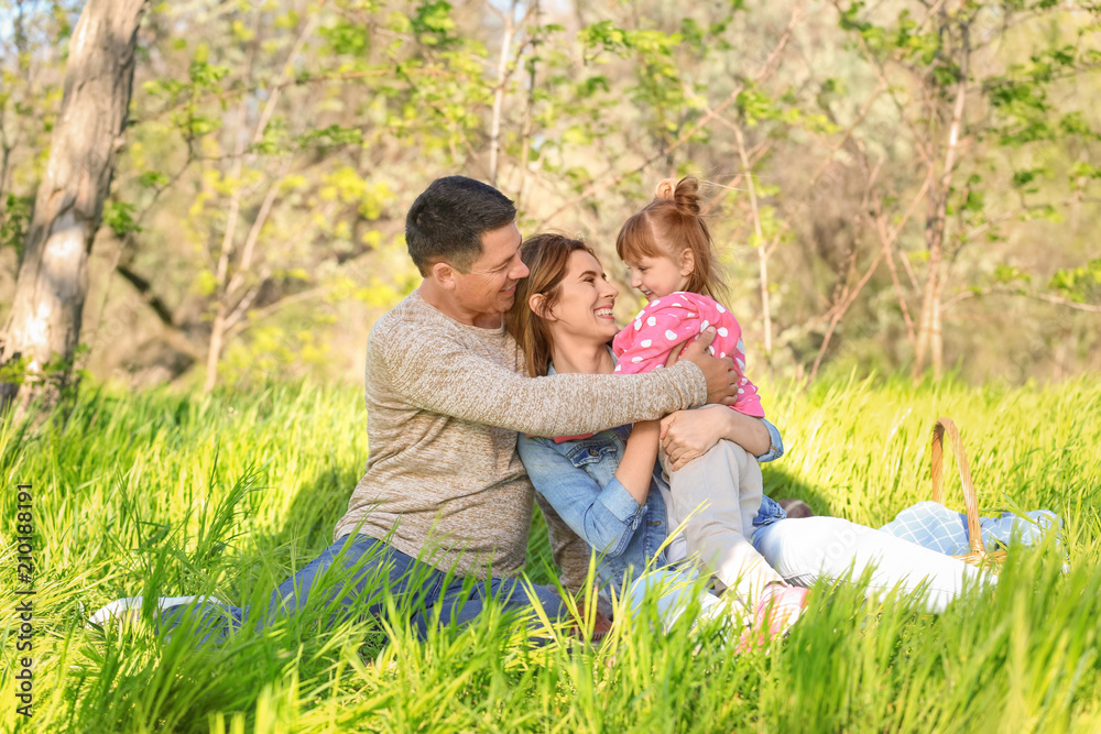 Happy family resting in park Happy family resting in park