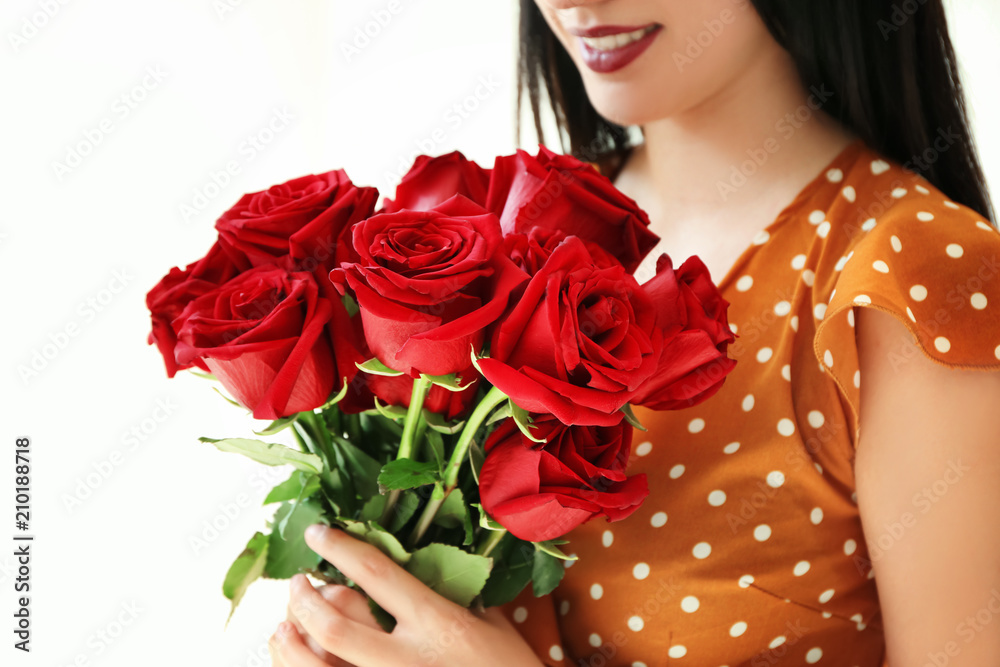 Woman holding beautiful roses on white background