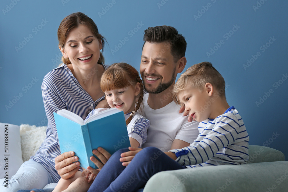 Parents and their children reading book together at home Parents and their children reading book together at home