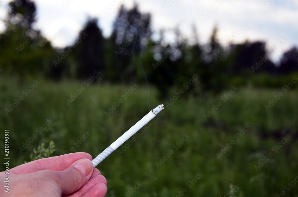 Cigarette in hand. Smoking person. Pernicious habits. Harm to health. Healthy lifestyle. do not smoke. Cigarette in hand. Smoking person. Pernicious habits. Harm to health. Healthy lifestyle. do not smoke.