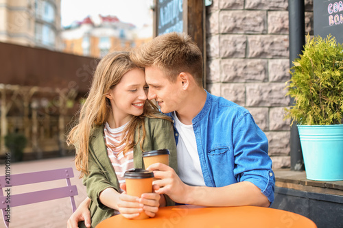 Happy young couple in cafe ...