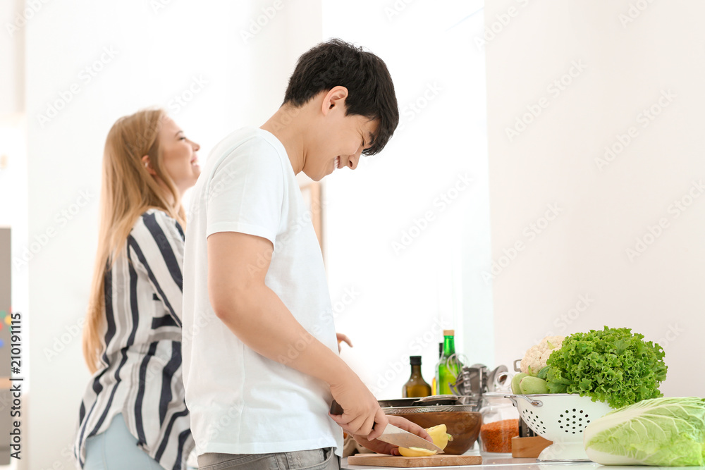 Friends cooking together in kitchen Friends cooking together in kitchen