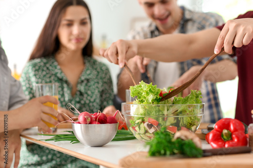Friends cooking together in...