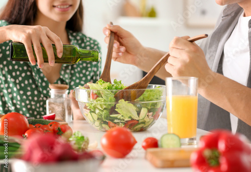 Friends cooking together in...