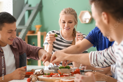 Friends cooking together in...