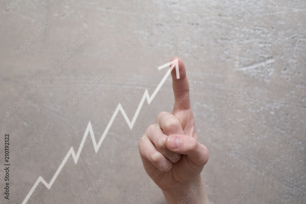 Business development and long term growing up revenue concept. Finger touching transparent arrow graph growth or increase business chart on grunge light brown background with copy space for text or im Business development and long term growing up revenue concept. Finger touching transparent arrow graph growth or increase business chart on grunge light brown background with copy space for text or im