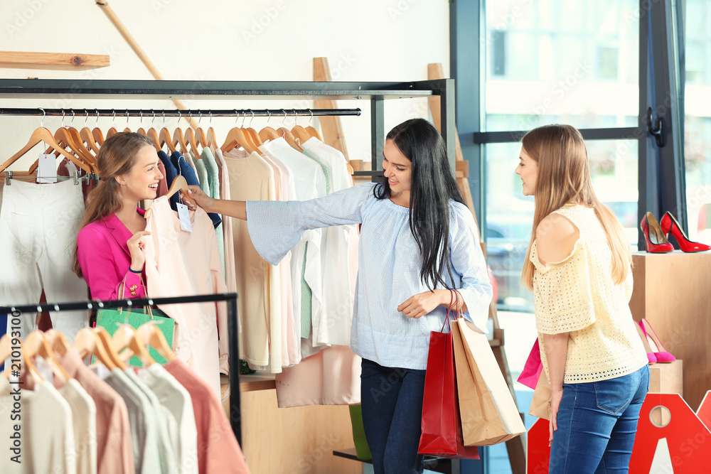 Beautiful young girls choosing clothes in shop Beautiful young girls choosing clothes in shop