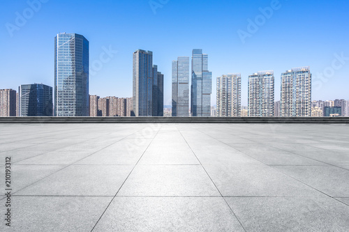 empty square with panoramic city skyline © THINK b