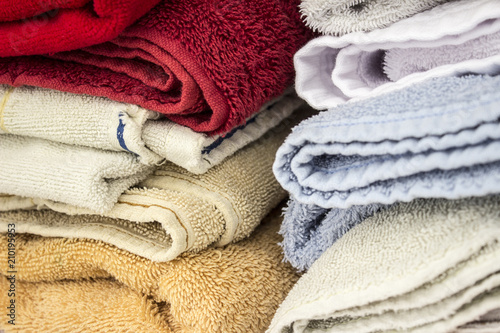A stack of colorful household towels. They're are red, blue and yellow. © Osvaldo