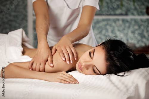 Relaxed woman receiving massage