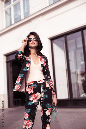 Fashionable brunette woman dressed in nice clothes, sunglasses walking in the street. Fashion spring summer photo © Wojciech