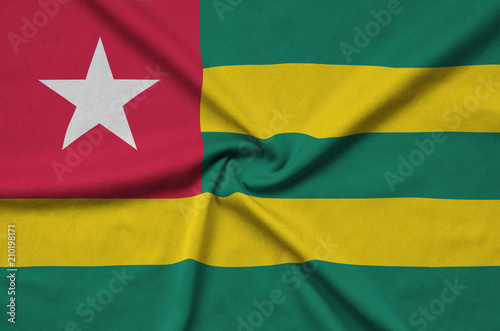 Togo flag  is depicted on a sports cloth fabric with many folds. Sport team banner photo