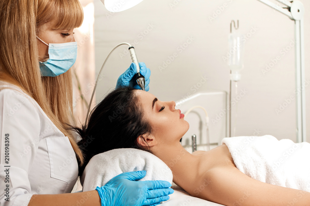 Beautician makes cleaning of face in spa salon. Beautician makes cleaning of face in spa salon.