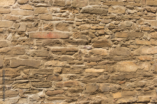 Texture of stone wall from oblong brown stones, background photo