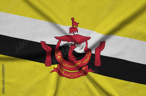 Brunei Darussalam flag  is depicted on a sports cloth fabric with many folds. Sport team banner photo