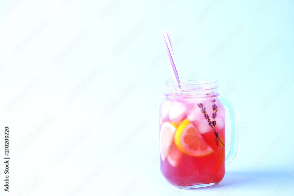 Red berry lavander lemonade, lemon & straw. Virgin strawberry mojito, non alcoholic cocktail with ice in vintage mason jar glass, Isolated on pale blue white background. Copy space, top view, close up Red berry lavander lemonade, lemon & straw. Virgin strawberry mojito, non alcoholic cocktail with ice in vintage mason jar glass, Isolated on pale blue white background. Copy space, top view, close up