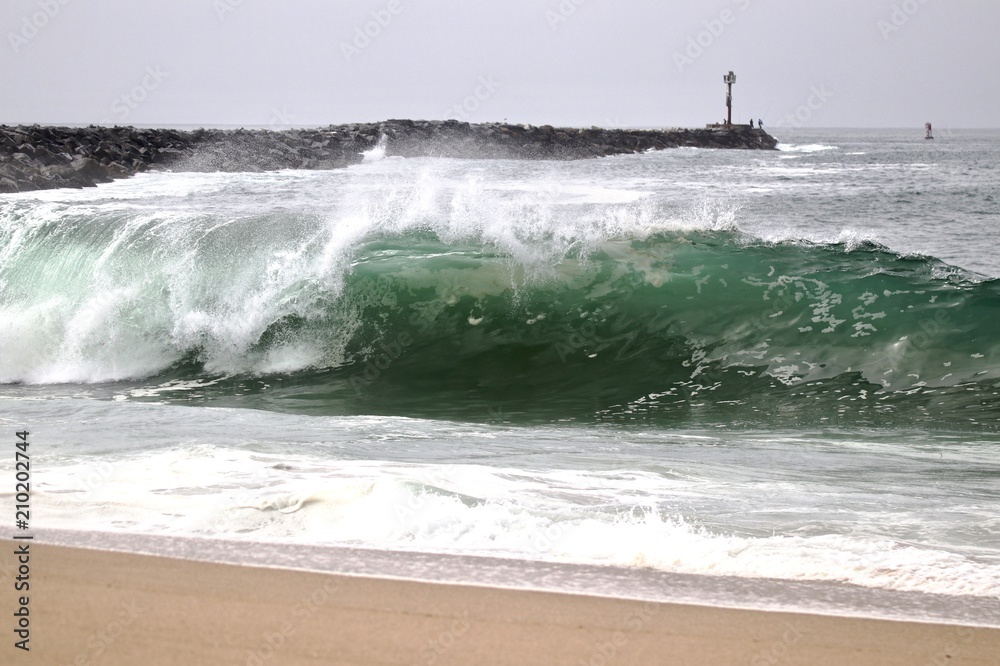 Large powerful wave crashing on the shore