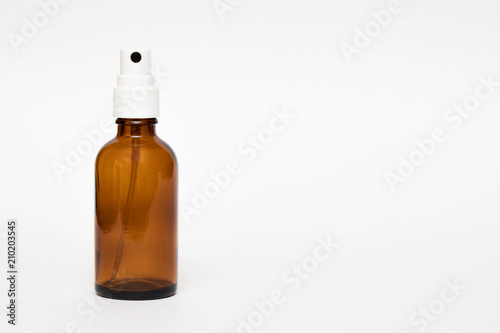 A brown bottle for essential oils and cosmetic products. Glass bottle on white background. A dropper, a bottle with a sprayer, a jar. Mockup isolated on white
