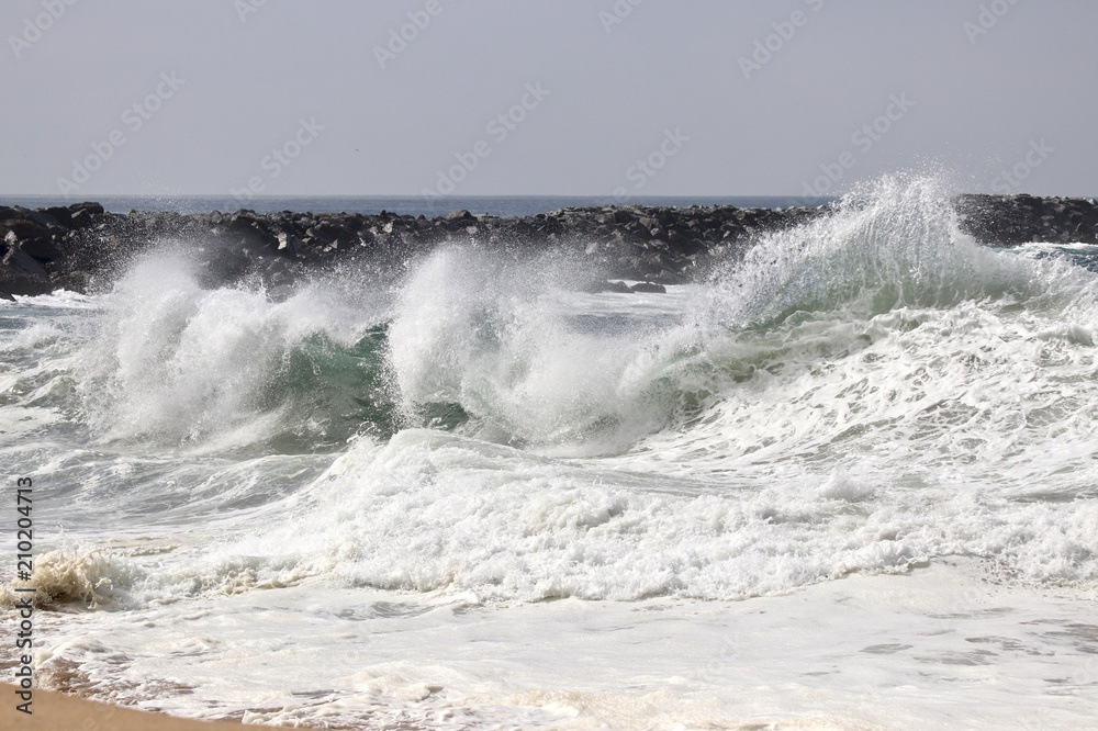 large powerful wave crashing on the shore 