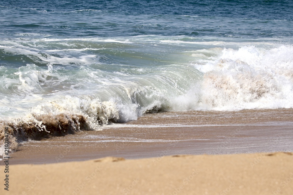 wave washing up on a sandy shore