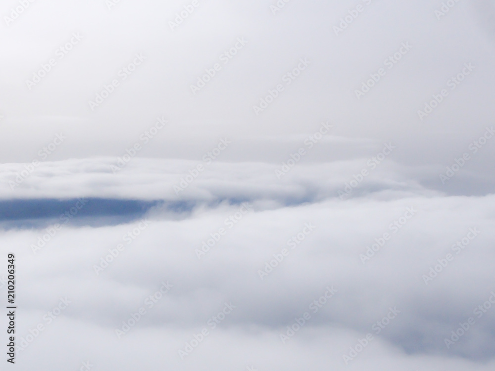 Sky and Clouds View from above through a window airplane at sunrise