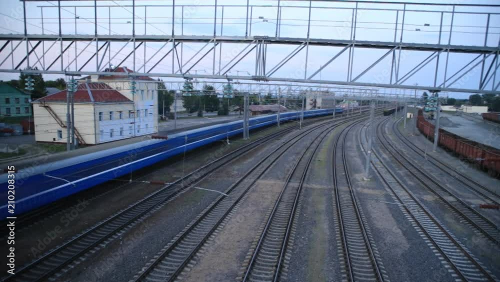 Passenger train rides the station, top view, time-laps Passenger train rides the station, top view, time-laps