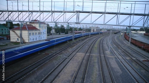 Passenger train rides the station, top view, time-laps photo