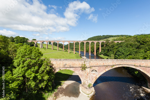 Leaderfoot Viaduct.  Leaderfoot Viaduct in the background is a disused railway viaduct over the River Tweed in the Scottish Borders.  In the foreground is Drygrange Old Bridge a disused road bridge. photo