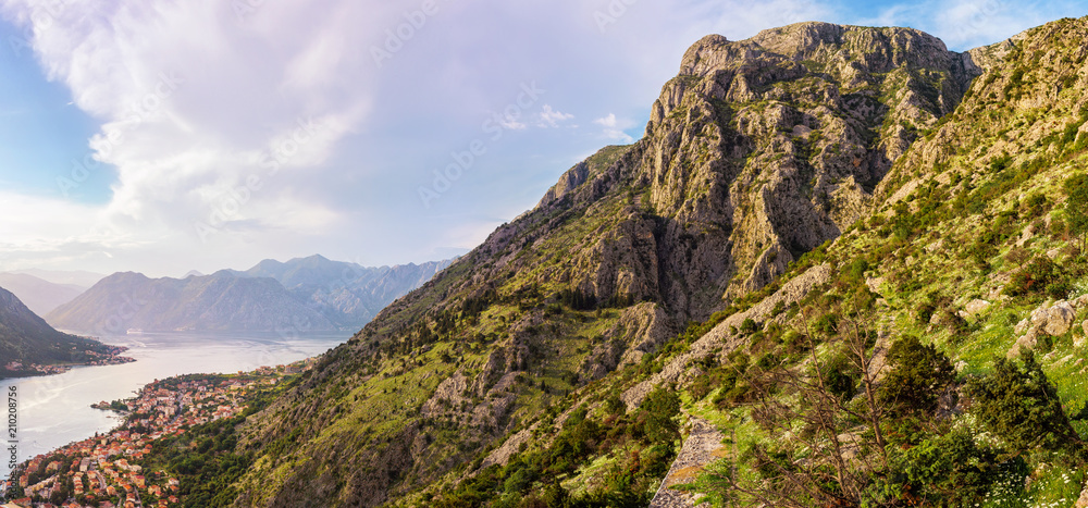 Panoramic view on the high mountains above the old city Kotor in Adriatic sea coastline in Montenegro, sunset time, gorgeous nature landscape