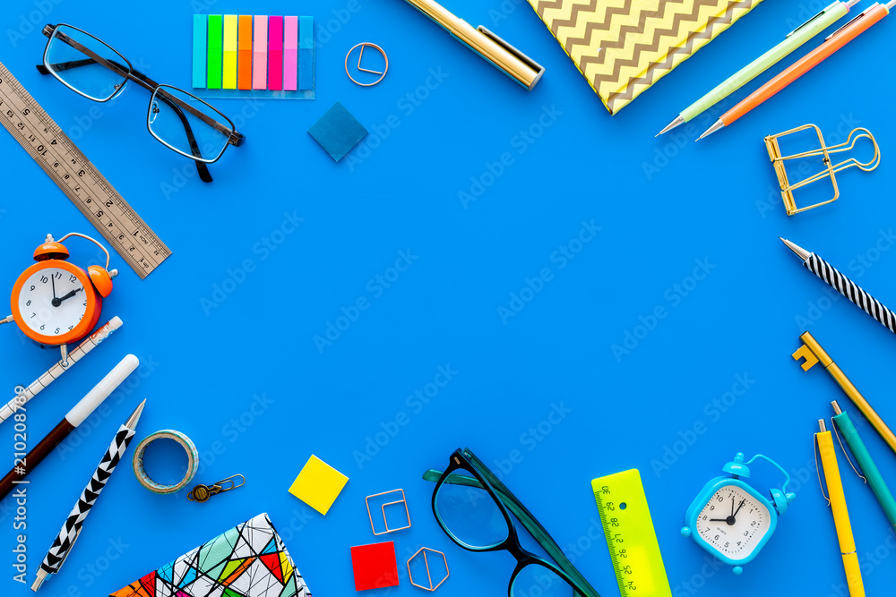 Education background, mockup. School, student, office supplies. Stationery,  glasses, alarm clock, notebook on blue background top view copy space Stock  Photo | Adobe Stock