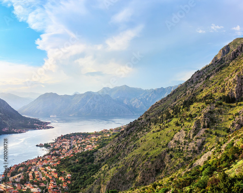 Panoramic view from above on the old city Kotor, bay in Adriatic sea and mountains in Montenegro at sunset time, gorgeous nature landscape