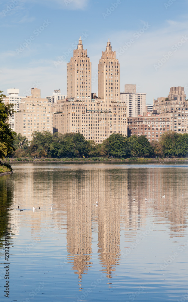 Jackie Onassis Reservoir. The view across the Jackie Onassis Reservoir in Central Park, New York City in the United States of America on a still autumn morning. Jackie Onassis Reservoir. The view across the Jackie Onassis Reservoir in Central Park, New York City in the United States of America on a still autumn morning.