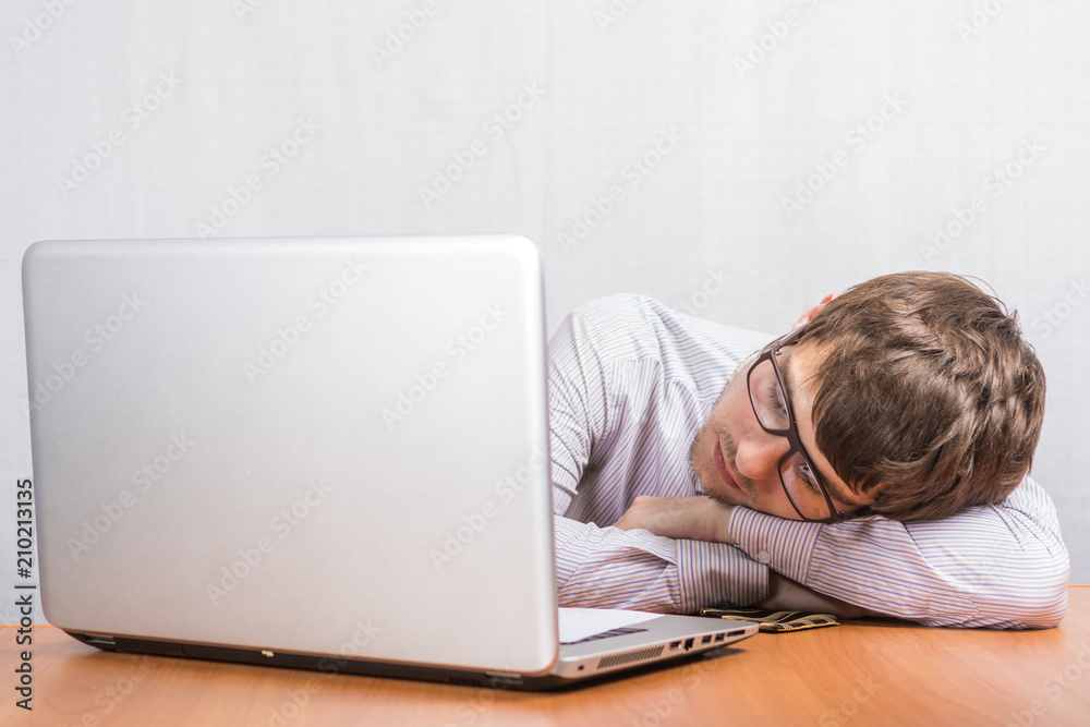 Young man sleeping at his Desk Young man sleeping at his Desk