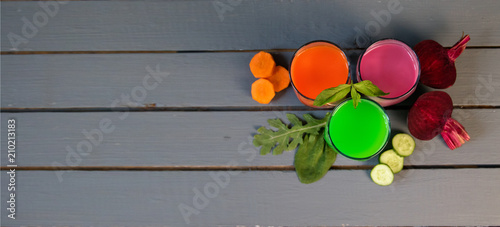 Healthy vegetable smoothie and juice on grey wooden backround. banner