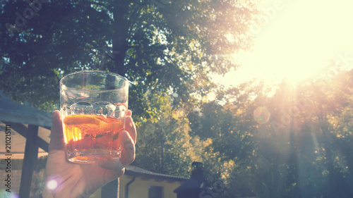 enjoying cocktail in sunset, appetizer to drink outdoor (vintage effect) 