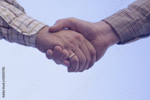 Handshake of two man as symbol agreement on establishing friendship and cooperation