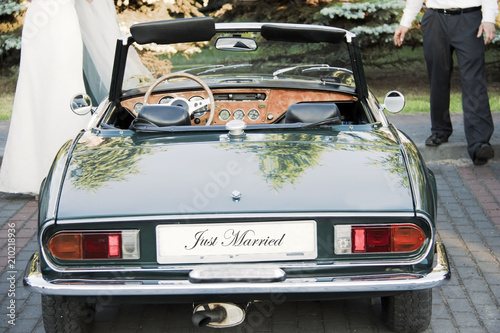 Bride with bridegroom and wedding car with 