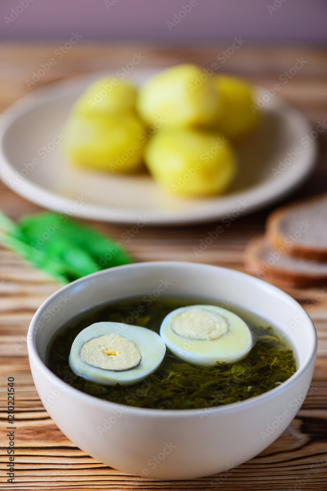 Sorrel soup on a wooden table. Holodnik. Traditional russian food. Rustic style Sorrel soup on a wooden table. Holodnik. Traditional russian food. Rustic style