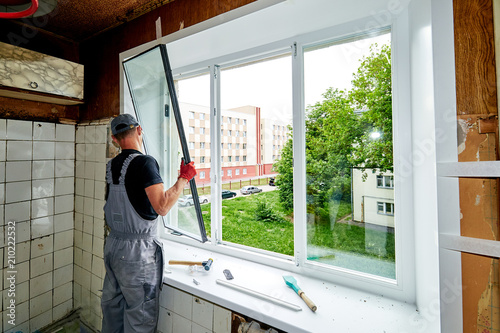 a man puts a plastic window