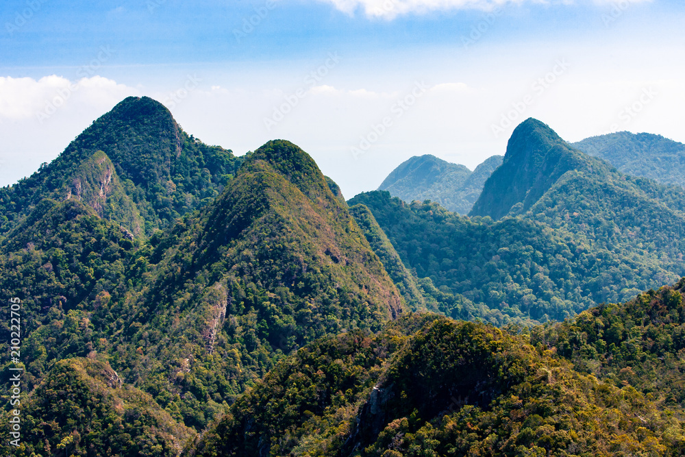 Mountains with tropical green forest and blue sky, Langkawi island, Asia