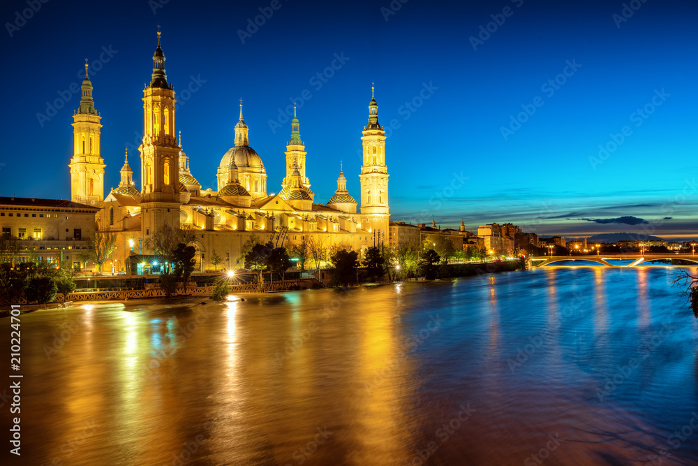 Zaragoza city, Spain, view over river to Cathedral at evening