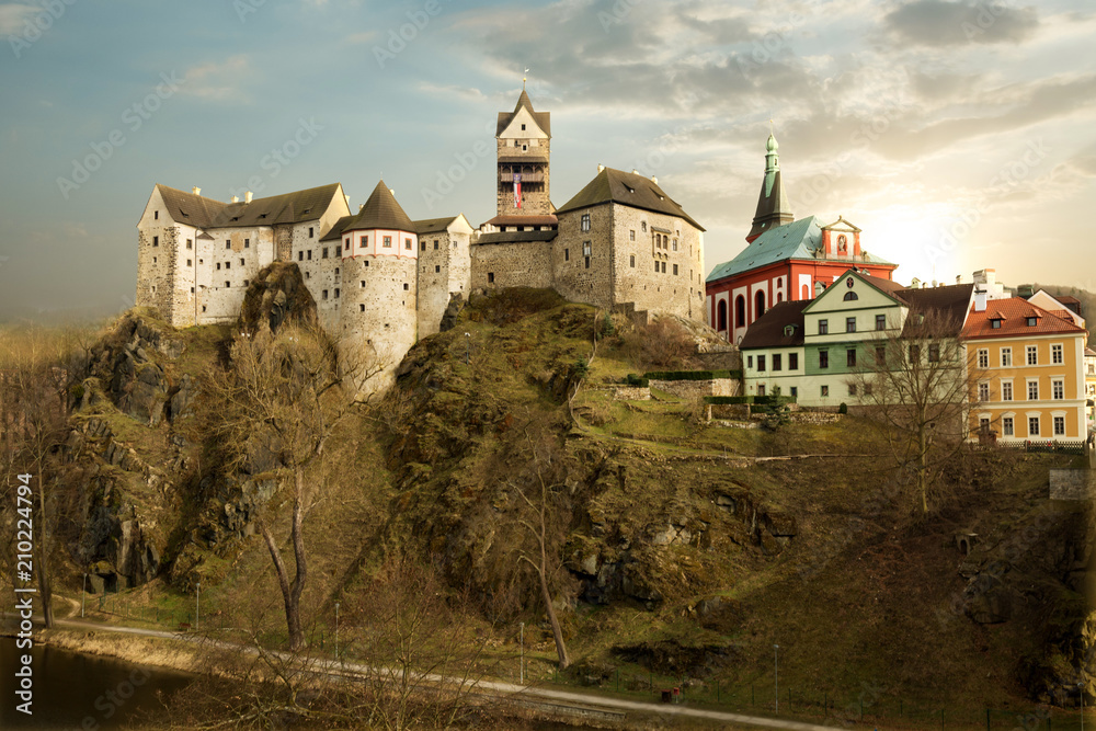 Amazing landmark in Czech Republic, near Karlovy Vary Loket middleaged castle with sunset and blue sky in spring.