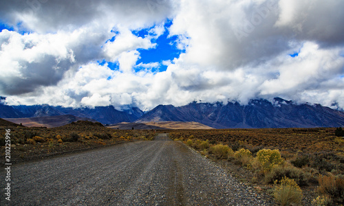 Road heading to mountains on cloudy day