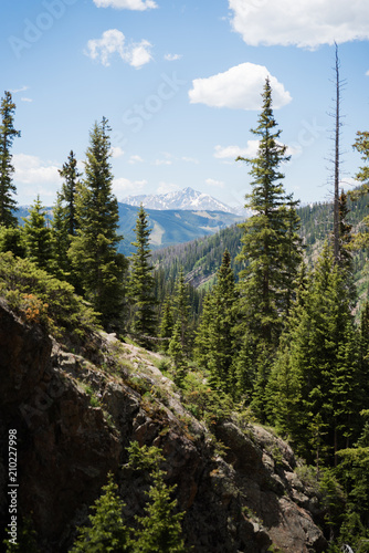Landscape view of Mount of the Holy Cross seen through a forest near Vail, Colorado. 
