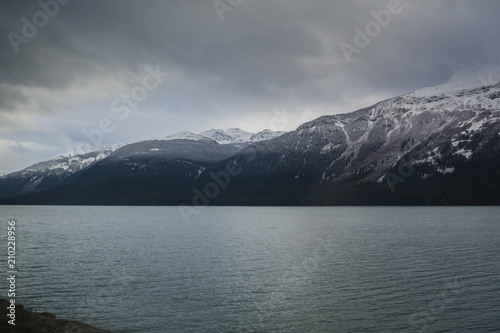 Beautiful snow covered Rocky Mountains by a azure colored lake