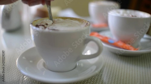 The spoon at the cup of coffee cappuccino