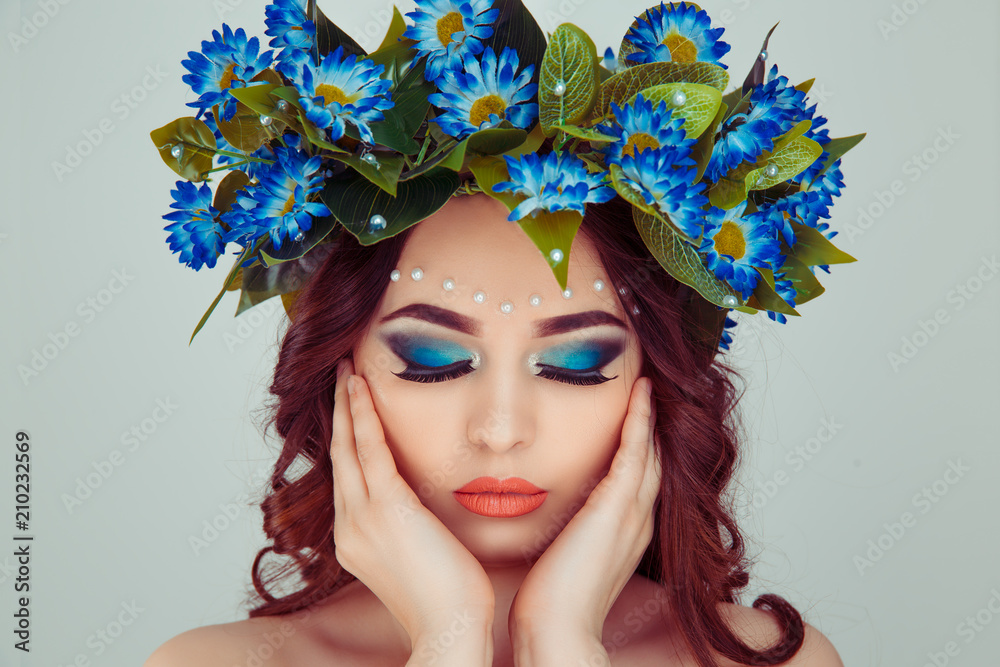 model with blue daisy flowers on head