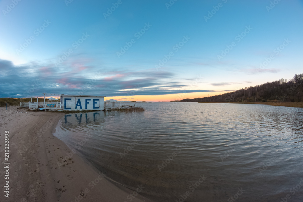 Flooded cafe on the shore of a small lagoon after storm.