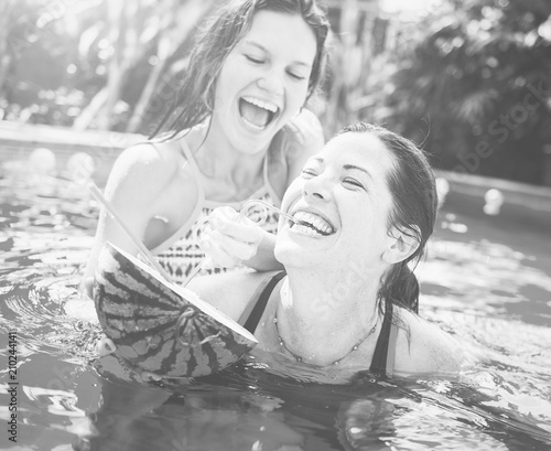 Mother and daughter having fun in pool