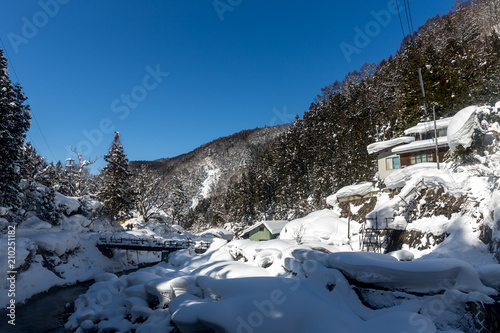 A famous valley hot spring covered in snow at Yamanouchi in Nagano. photo
